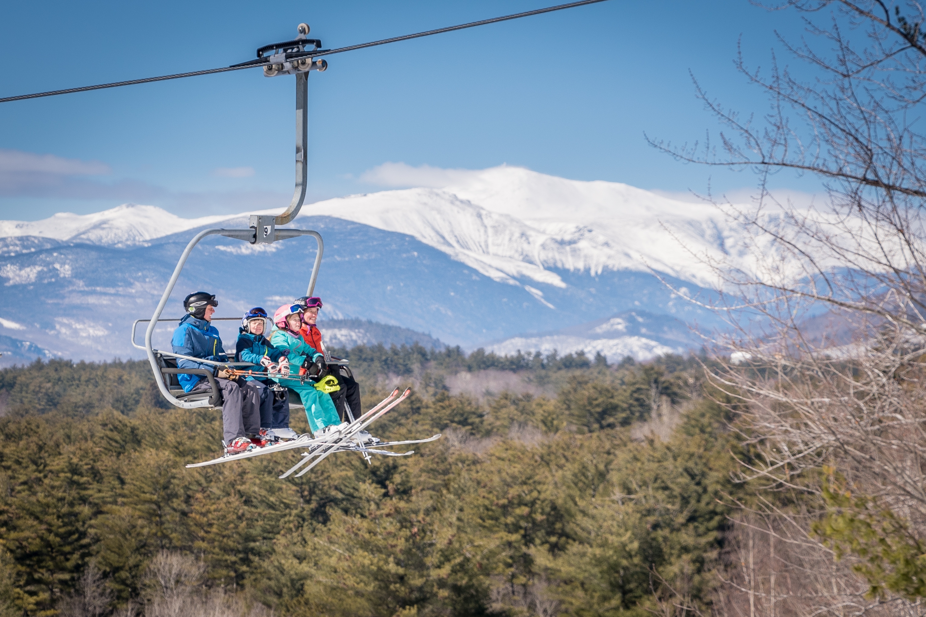 Family on lift Mt Washington in background